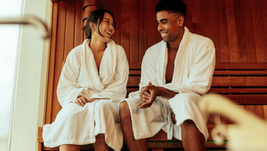 Happy couple relaxing in a sauna, enjoying a spa day or wellness retreat during their vacation.